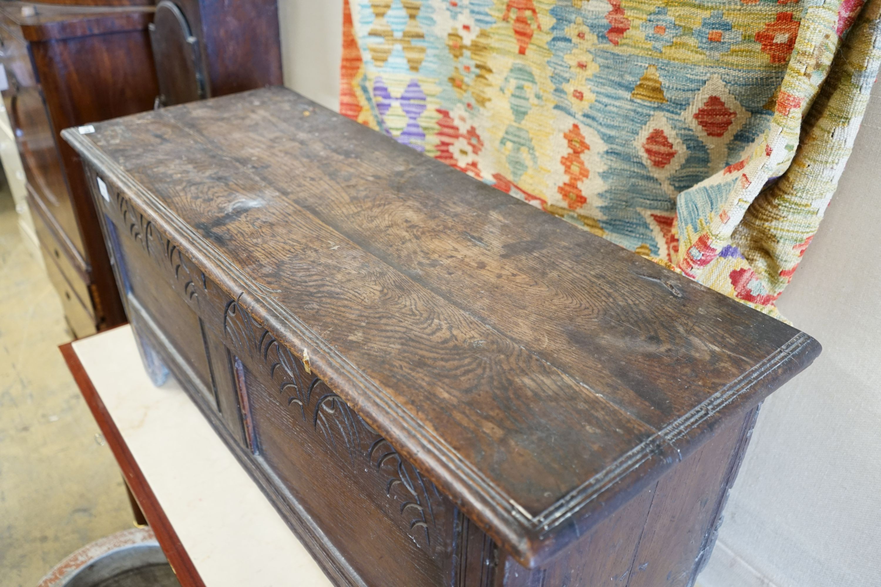 A 17th century and later carved oak six plank coffer, length 117cm, depth 43cm, height 56cm